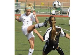 HIGHER GROUND:  Troy’s Kayla Porter (No. 2 on left) gets a leg up on North Farmington’s Carina Wright during Wednesday’s Division 1 regional semifinals. Photo | Ken Swart, Swart Photography.